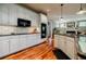 Elegant kitchen with white cabinetry, stainless steel appliances, and hardwood floors, offering a functional and stylish design at 3620 Chartwell Dr, Suwanee, GA 30024