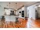 Modern kitchen with stainless steel appliances, center island with seating, and beautiful hardwood floors at 3620 Chartwell Dr, Suwanee, GA 30024