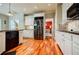 Stylish kitchen showcasing stainless steel appliances, white cabinetry, and hardwood floors, creating a clean and modern look at 3620 Chartwell Dr, Suwanee, GA 30024