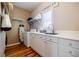 Well-organized laundry room with ample cabinet space, white countertops, and a convenient sink for added functionality at 3620 Chartwell Dr, Suwanee, GA 30024
