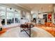 Bright open living area featuring hardwood floors, a large window, and modern kitchen with stainless steel appliances at 3620 Chartwell Dr, Suwanee, GA 30024