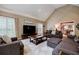 Inviting living room with vaulted ceilings, plush seating, and large windows, creating a bright and comfortable space at 3620 Chartwell Dr, Suwanee, GA 30024