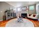 Inviting living room with a fireplace, hardwood floors, and stylish furnishings, creating a warm and relaxing ambiance at 3620 Chartwell Dr, Suwanee, GA 30024