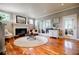 Cozy living room featuring a fireplace, hardwood floors, and ample natural light, ideal for comfortable living at 3620 Chartwell Dr, Suwanee, GA 30024