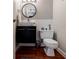 Stylish powder room featuring a modern vanity, vessel sink, sleek fixtures, and hardwood floors at 3620 Chartwell Dr, Suwanee, GA 30024