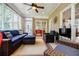 Bright and airy sunroom with wicker furniture, offering a peaceful retreat with views of the surrounding greenery at 3620 Chartwell Dr, Suwanee, GA 30024