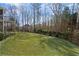 A picturesque backyard with a lush green lawn and mature trees creates a serene outdoor oasis at 4115 Gold Mill Rdg, Canton, GA 30114