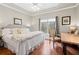 Comfortable bedroom with a tray ceiling, hardwood floors, and plenty of natural light at 4115 Gold Mill Rdg, Canton, GA 30114