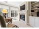 Bedroom with fireplace, tv, built-ins, and oversized windows with nature views at 4115 Gold Mill Rdg, Canton, GA 30114