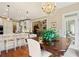 Bright dining area features a chandelier, wood floors, and a door to the outdoors at 4115 Gold Mill Rdg, Canton, GA 30114