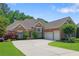 Beautiful brick home featuring manicured landscaping, a spacious driveway, and an attached two-car garage at 4115 Gold Mill Rdg, Canton, GA 30114