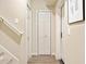 Hallway with multiple closets, neutral walls, and stairs leading up at 4115 Gold Mill Rdg, Canton, GA 30114