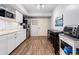 Kitchenette offers white cabinets, modern appliances, and a long dining table at 4115 Gold Mill Rdg, Canton, GA 30114