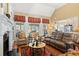 Bright living room featuring a fireplace, hardwood floors, and access to the porch at 4115 Gold Mill Rdg, Canton, GA 30114