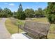 Image of a park bench along a walking trail with landscaping and nearby houses at 4115 Gold Mill Rdg, Canton, GA 30114