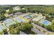 Aerial view of the community tennis courts, parking, lake, and clubhouse surrounded by lush landscaping at 4115 Gold Mill Rdg, Canton, GA 30114