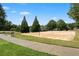 Image of the sand volleyball court with a walking trail and bench at 4115 Gold Mill Rdg, Canton, GA 30114