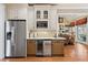 Wet bar featuring stainless steel fridge, microwave, and wine storage at 4115 Gold Mill Rdg, Canton, GA 30114