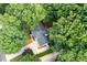 Aerial view of the home surrounded by lush trees and landscaping, and a spacious driveway at 4429 Windsor Oaks Cir, Marietta, GA 30066