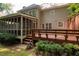 Exterior view of a home with a screened-in porch and wooden deck overlooking a lush backyard at 4429 Windsor Oaks Cir, Marietta, GA 30066