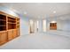 Finished basement with neutral carpet, custom shelving, and ample storage space at 4429 Windsor Oaks Cir, Marietta, GA 30066