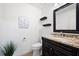 Neat bathroom with a stylish vanity, granite countertop, and decorative shelving at 4429 Windsor Oaks Cir, Marietta, GA 30066