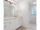 Bathroom with a white vanity, updated mirror, and a tub-shower with mosaic accents at 4429 Windsor Oaks Cir, Marietta, GA 30066