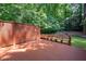 Outdoor deck with built-in seating surrounded by mature trees and landscaping at 4429 Windsor Oaks Cir, Marietta, GA 30066