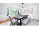 Elegant dining room featuring a modern light fixture, decorative molding, and large windows at 4429 Windsor Oaks Cir, Marietta, GA 30066