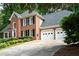 Stately two-story brick home with well-manicured lawn and a two-car garage at 4429 Windsor Oaks Cir, Marietta, GA 30066