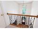 Foyer with wrought iron railing and a view of the front door and transom window at 4429 Windsor Oaks Cir, Marietta, GA 30066