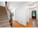 Hallway with staircase and hardwood floors leads to an elegant front door at 4429 Windsor Oaks Cir, Marietta, GA 30066