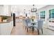 Eat-in kitchen features white cabinets, granite counters, and a breakfast nook with bright natural light at 4429 Windsor Oaks Cir, Marietta, GA 30066