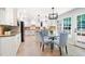 Open kitchen and breakfast nook with white cabinets, granite countertops, stainless steel appliances, and sunlit windows at 4429 Windsor Oaks Cir, Marietta, GA 30066