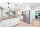Well-lit kitchen featuring white cabinets, granite countertops, stainless steel appliances, and an adjacent dining area at 4429 Windsor Oaks Cir, Marietta, GA 30066