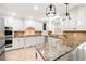 Bright kitchen with white cabinets, granite countertops, stainless steel appliances, and brick backsplash at 4429 Windsor Oaks Cir, Marietta, GA 30066