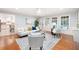 Bright living room with hardwood floors, white sofa, and windows letting in natural light at 4429 Windsor Oaks Cir, Marietta, GA 30066
