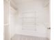 Spacious walk-in closet featuring white shelving and rod for optimal organization and storage at 4429 Windsor Oaks Cir, Marietta, GA 30066