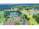 Panoramic aerial view featuring tennis courts, a golf course, and a scenic lake at 3070 Ascot Ln, Roswell, GA 30076