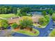 Overhead shot of clubhouse with manicured landscaping, tennis courts, and golf course at 3070 Ascot Ln, Roswell, GA 30076