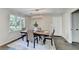 Cozy dining room with stylish table set, modern lighting, and natural light from a large window at 3070 Ascot Ln, Roswell, GA 30076