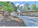Charming home with stone accents, a long driveway, and an attached two-car garage at 3070 Ascot Ln, Roswell, GA 30076