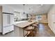 Spacious kitchen featuring a large island, white cabinets, stainless appliances, and an adjacent breakfast area at 3070 Ascot Ln, Roswell, GA 30076