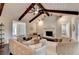 Cozy living room with vaulted ceilings, exposed beams, a fireplace, and neutral-toned furniture at 3070 Ascot Ln, Roswell, GA 30076