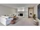 Bright living room with a stone fireplace, built-in shelves, and a white couch at 3070 Ascot Ln, Roswell, GA 30076