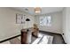 Bright office with a curved wooden desk, modern lighting, and dark wood flooring at 3070 Ascot Ln, Roswell, GA 30076