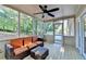 Cozy screened-in porch with comfortable seating and ceiling fan, ideal for relaxation at 3070 Ascot Ln, Roswell, GA 30076