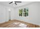 Bright bedroom features a ceiling fan, closet, and large window providing lots of natural light at 4745 Elam Forest Dr, Stone Mountain, GA 30083