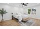 Bedroom with a ceiling fan, bed, side table, rug, chair, and a window with a view of the outdoors at 4745 Elam Forest Dr, Stone Mountain, GA 30083