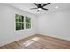 Bright bedroom features a ceiling fan and a window that offers a lush green view at 4745 Elam Forest Dr, Stone Mountain, GA 30083